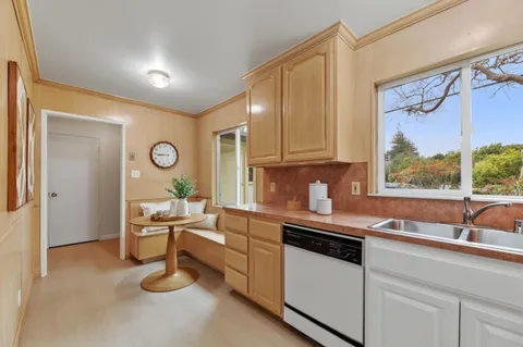 a kitchen with a sink cabinets and window