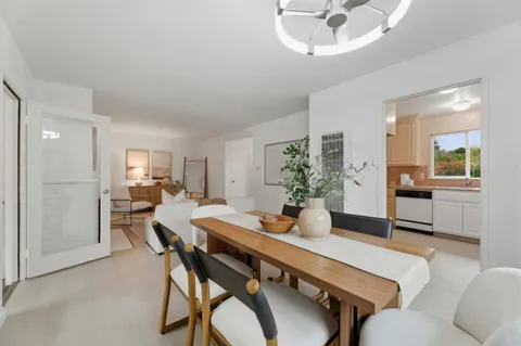 a dining room with furniture and window