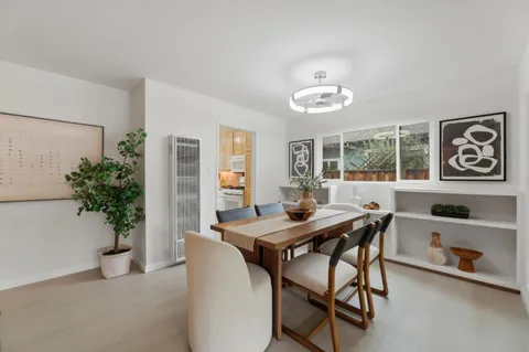 a view of a dining room with furniture and window
