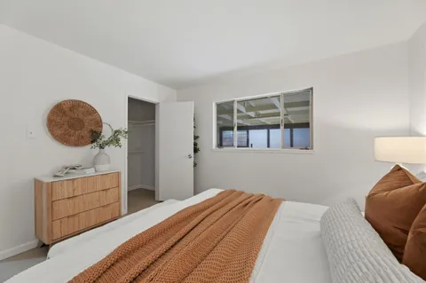 a bedroom with a bed and cabinets