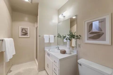 a bathroom with a sink toilet and shower