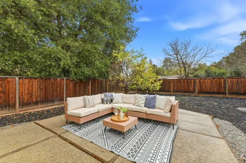 a outdoor living space with furniture and wooden fence