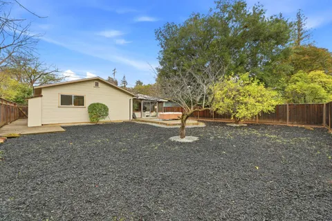 a view of a house with a backyard
