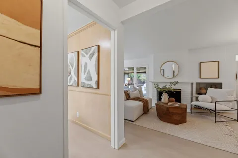 a living room with furniture a fireplace and a window