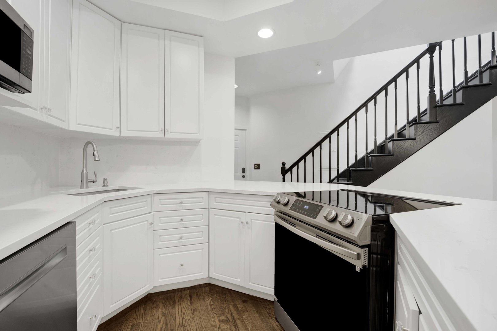 223 West Wisconsin Street, Unit 3A Chicago, IL 60614 - Photo 7 of 27 a kitchen with white cabinets and sink