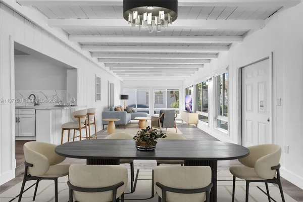 a view of a dining room with furniture and a chandelier