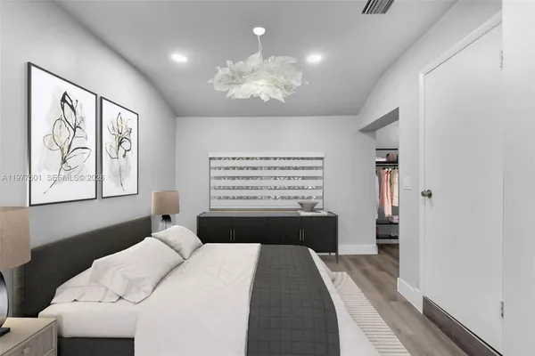 a bedroom with a large bed and a window