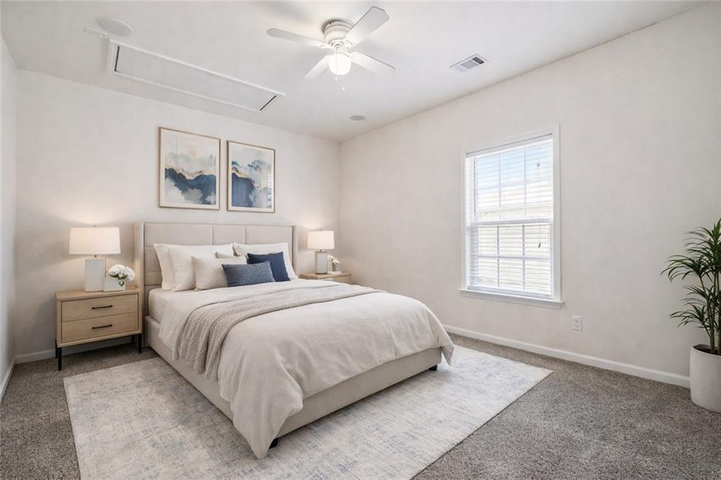 3155 Esplanade Circle Southwest Atlanta, GA 30311 - Photo 13 of 23 a bedroom with a large bed and a chandelier fan