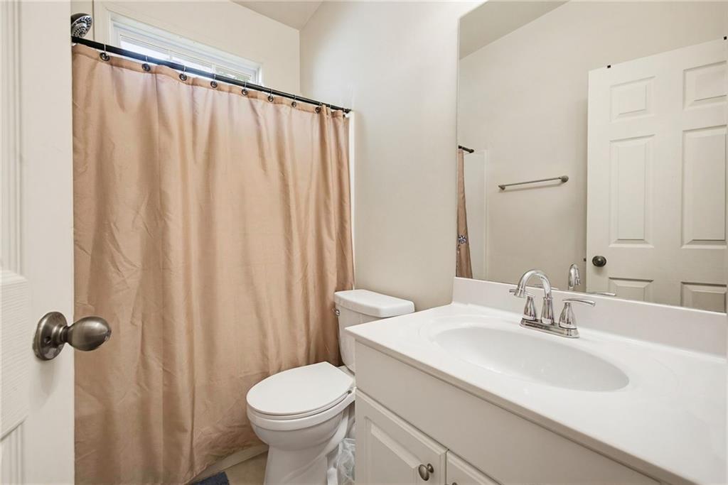3155 Esplanade Circle Southwest Atlanta, GA 30311 - Photo 15 of 23 a bathroom with a sink a toilet and shower curtain