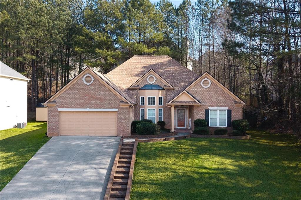 3155 Esplanade Circle Southwest Atlanta, GA 30311 - Photo 19 of 23 a front view of a house with a yard and garage