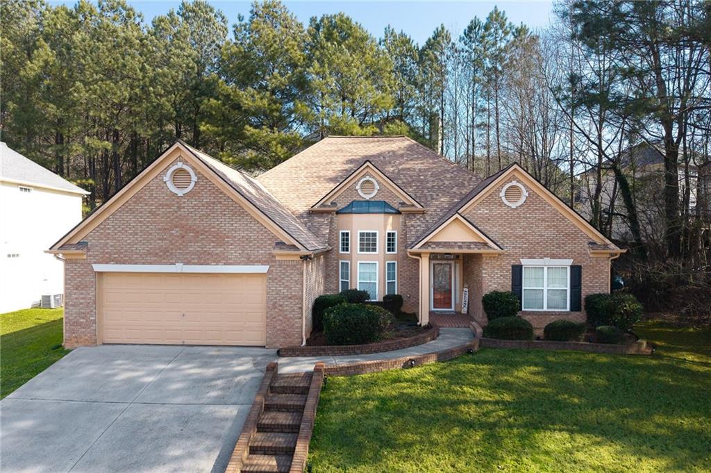 3155 Esplanade Circle Southwest Atlanta, GA 30311 - Photo 21 of 24 a front view of a house with a yard and garage
