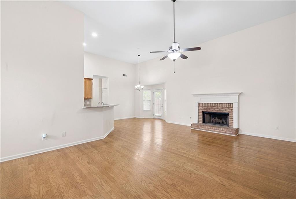 3155 Esplanade Circle Southwest Atlanta, GA 30311 - Photo 4 of 23 a view of an empty room with a fireplace and a chandelier fan