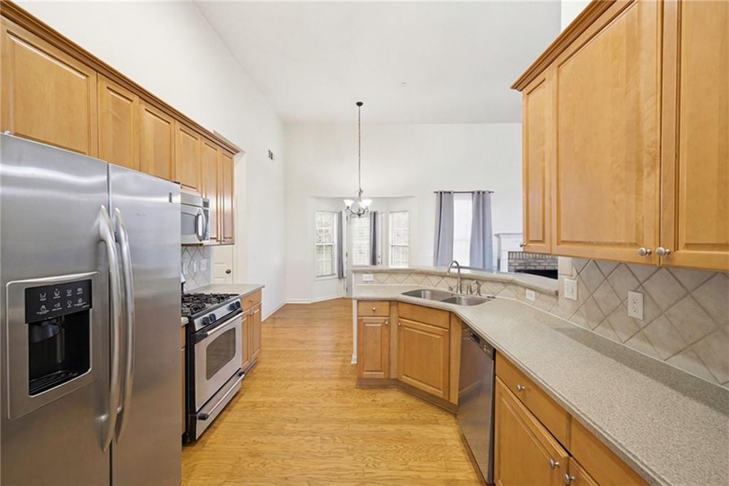 3155 Esplanade Circle Southwest Atlanta, GA 30311 - Photo 7 of 23 a kitchen with stainless steel appliances granite countertop a sink a stove and a refrigerator