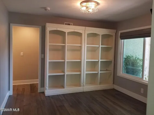 a view of a room with wooden floor and windows