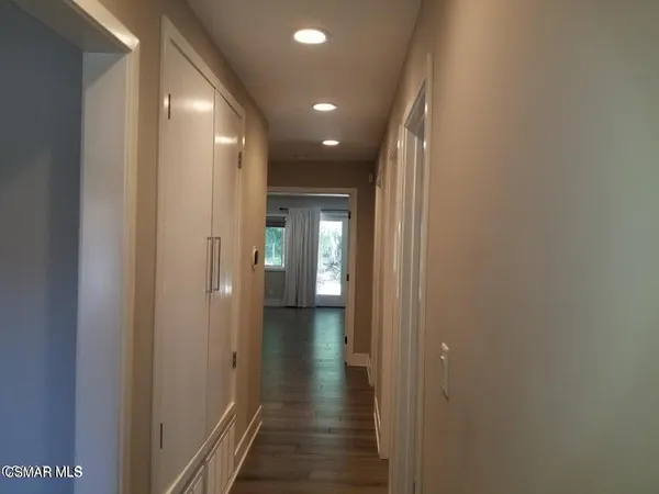 a view of hallway with wooden floor