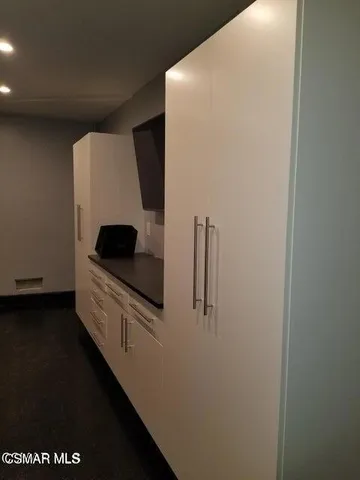 a kitchen with a refrigerator and a stove