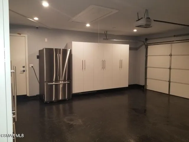 a view of a refrigerator in wooden floor