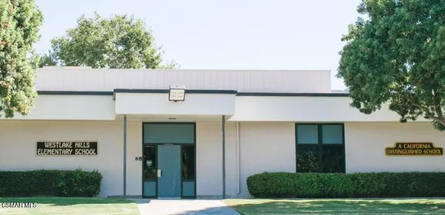 a view of a building with a tree in front