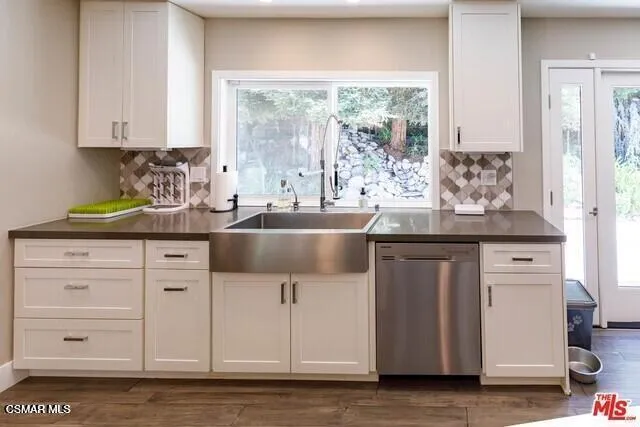 a kitchen with appliances cabinets and a sink
