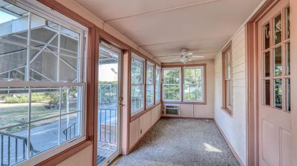a view of empty room with fireplace and windows