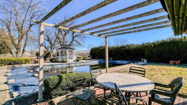 a view of a small yard in front of a house with a small yard and deck