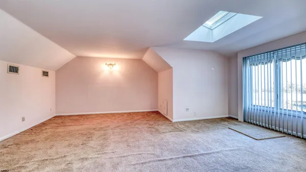 an empty room with closet and windows