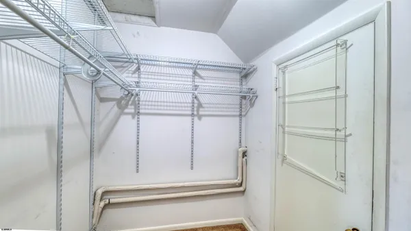 an empty room with furniture and a window