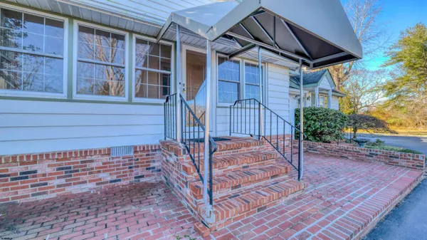 a view of a house with wooden floor and a yard