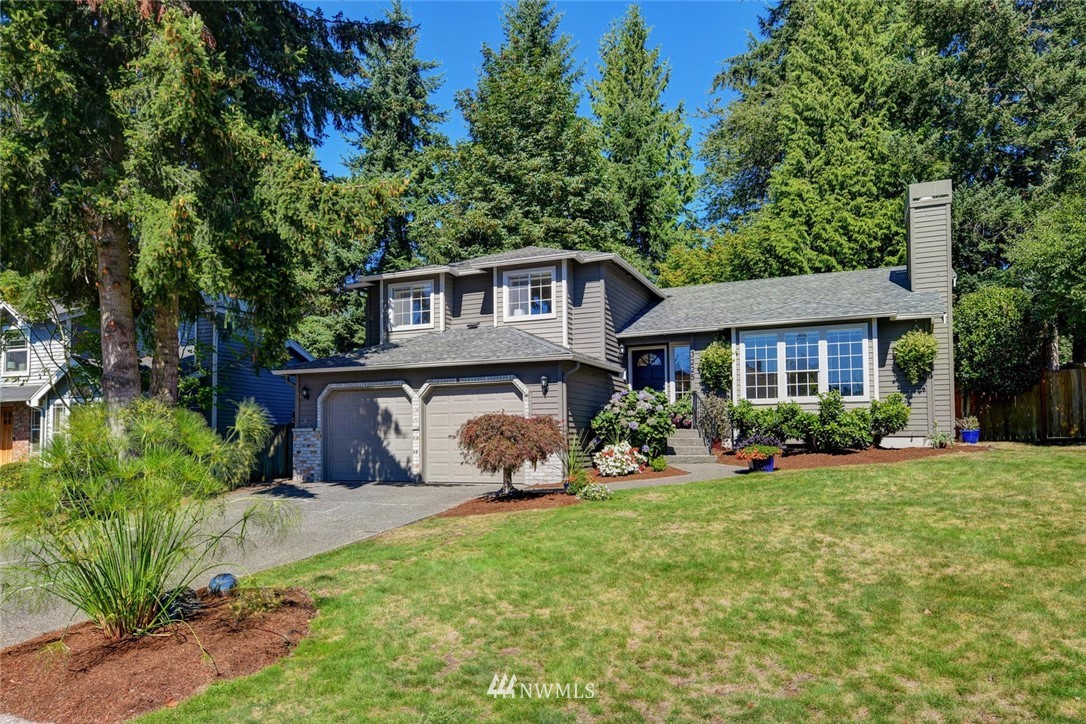 3225 208th Place Southeast Bothell, WA 98021 - Photo 1 of 28 a front view of a house with garden