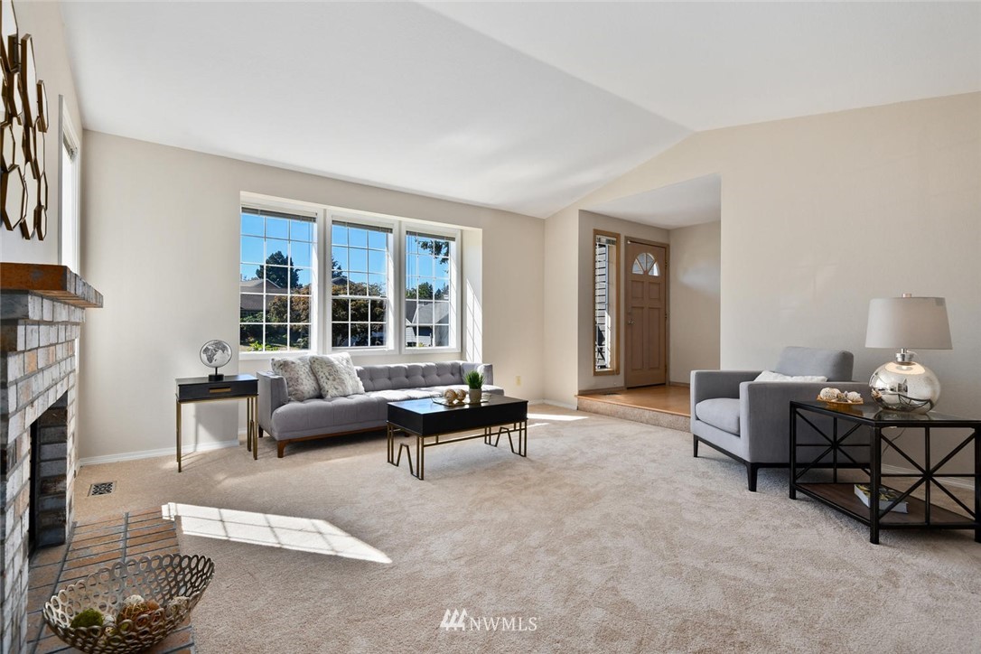3225 208th Place Southeast Bothell, WA 98021 - Photo 2 of 28 a living room with furniture and a fireplace