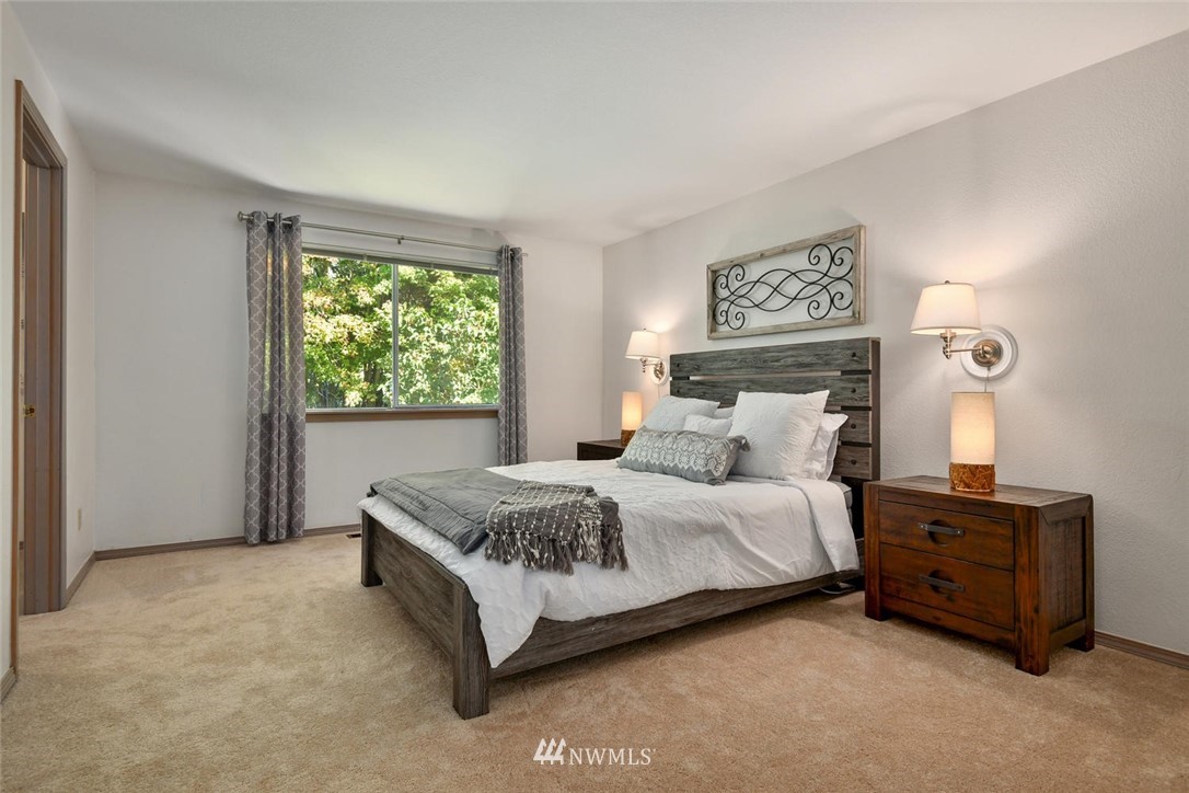 3225 208th Place Southeast Bothell, WA 98021 - Photo 12 of 28 a spacious bedroom with a bed and a window