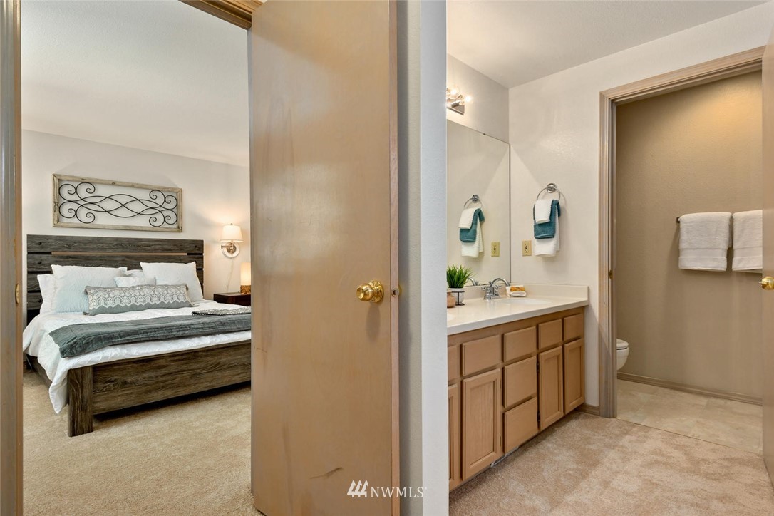 3225 208th Place Southeast Bothell, WA 98021 - Photo 13 of 28 a view of a bathroom with sink cabinet and mirror
