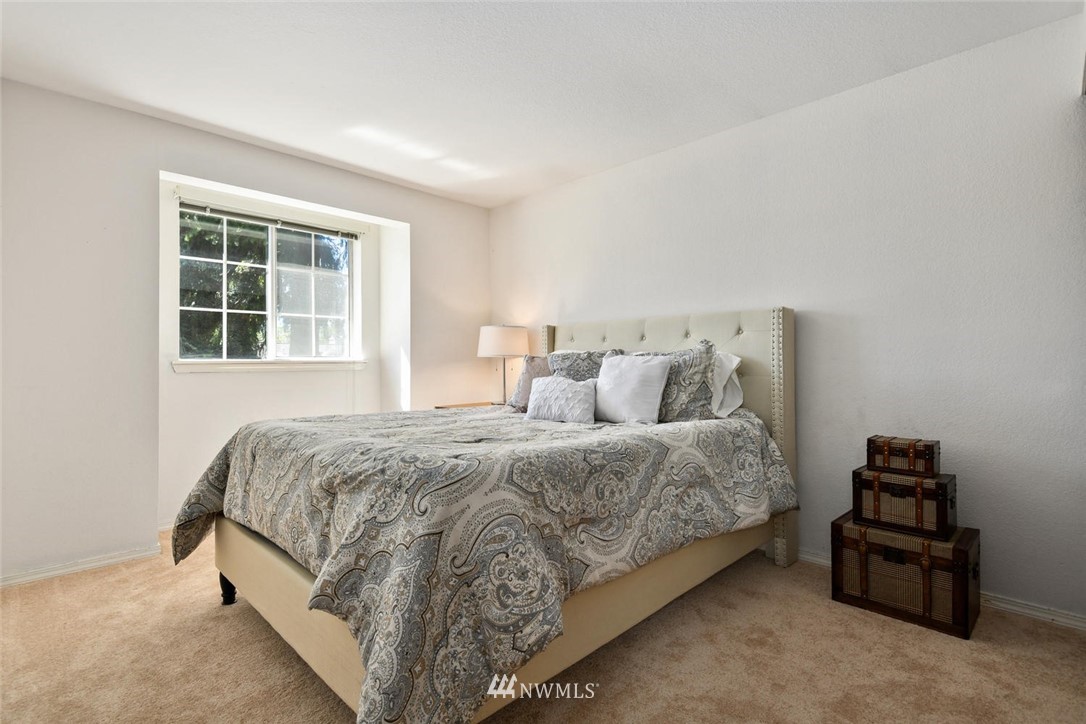 3225 208th Place Southeast Bothell, WA 98021 - Photo 17 of 28 a spacious bedroom with a bed and a window
