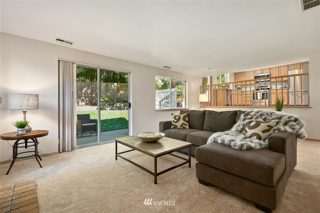 3225 208th Place Southeast Bothell, WA 98021 - Photo 9 of 28 a living room with furniture and a lamp