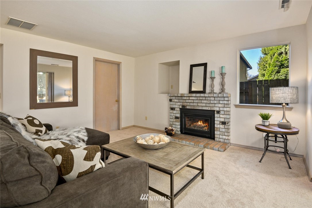 3225 208th Place Southeast Bothell, WA 98021 - Photo 10 of 28 a living room with furniture and a fireplace