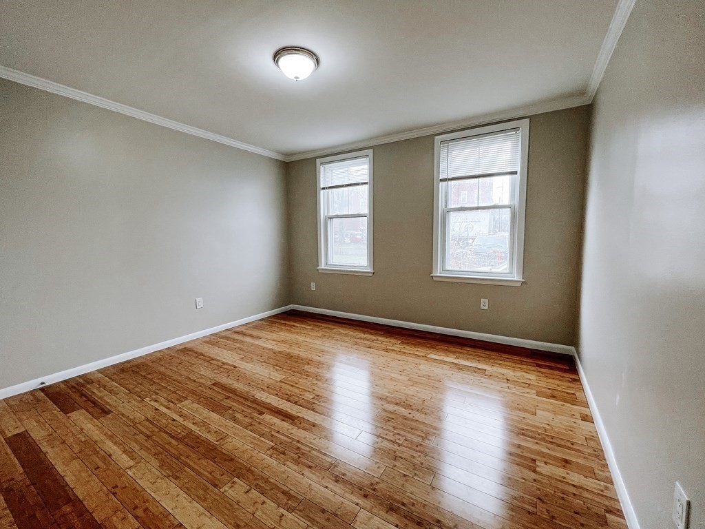 59-61 Division Street Chelsea, MA 02150 - Photo 12 of 13 an empty room with wooden floor and windows