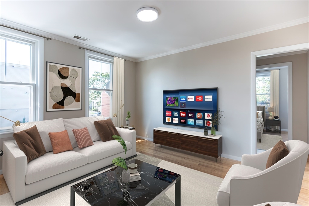 59-61 Division Street Chelsea, MA 02150 - Photo 3 of 13 a living room with furniture a rug and a flat screen tv