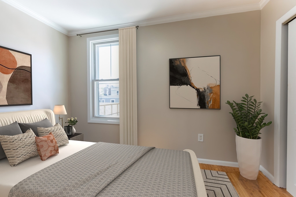 59-61 Division Street Chelsea, MA 02150 - Photo 5 of 13 a bedroom with a bed and a potted plant