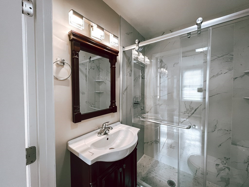 59-61 Division Street Chelsea, MA 02150 - Photo 10 of 13 a bathroom with a sink shower and a mirror