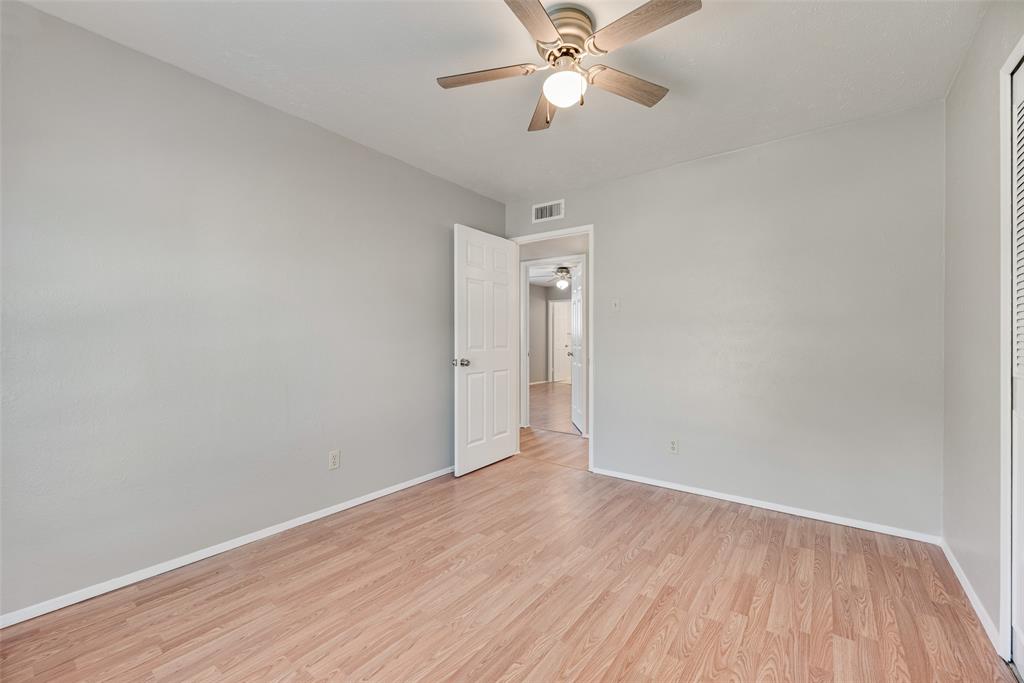 2002 Rose Hill Road Carrollton, TX 75007 - Photo 22 of 34 a view of an empty room with wooden floor