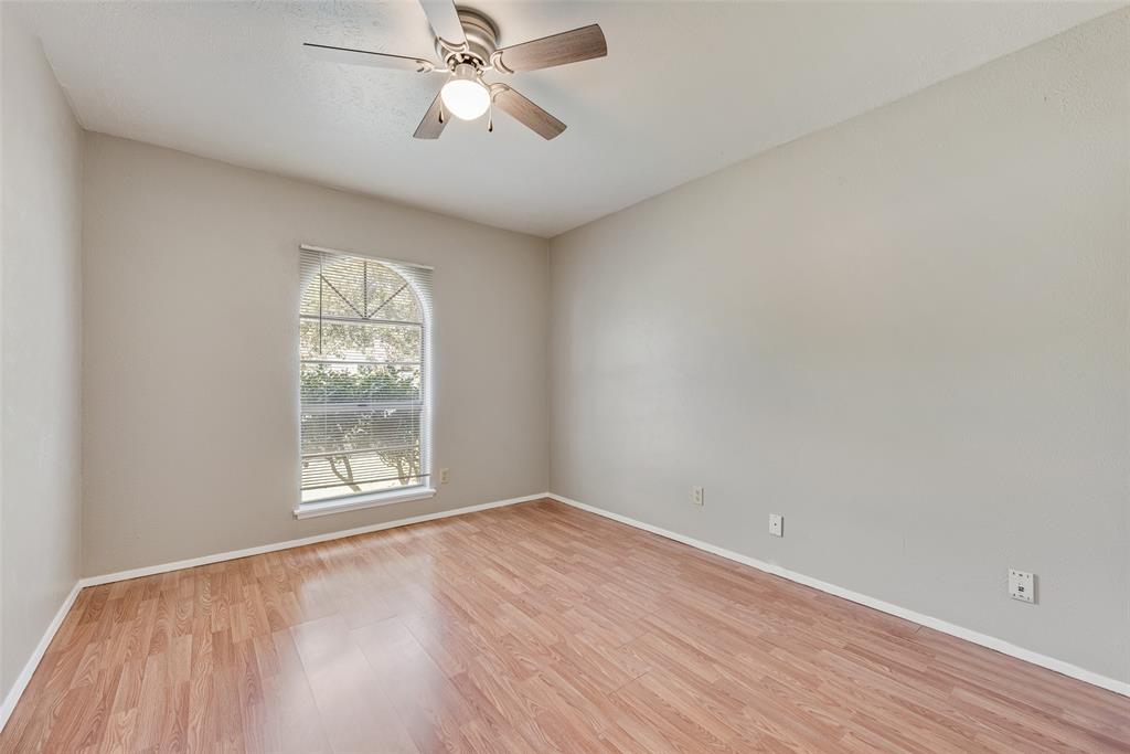2002 Rose Hill Road Carrollton, TX 75007 - Photo 23 of 34 an empty room with wooden floor fan and windows