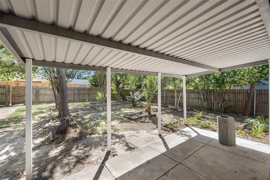 2002 Rose Hill Road Carrollton, TX 75007 - Photo 28 of 34 a view of a patio with table and chairs potted plants with floor to ceiling window