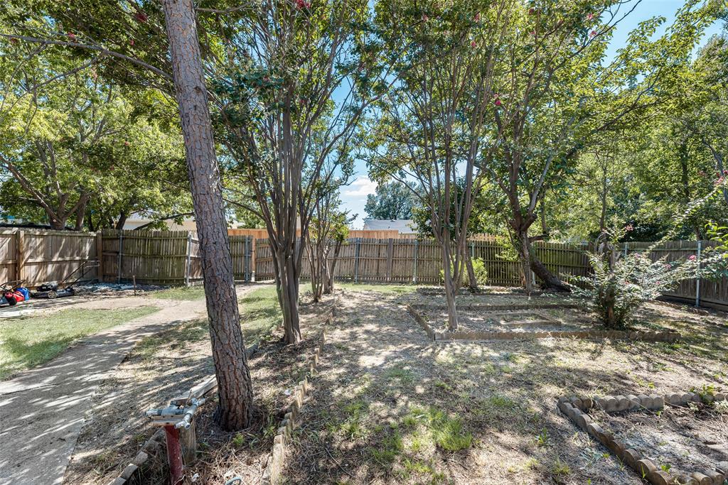2002 Rose Hill Road Carrollton, TX 75007 - Photo 29 of 34 a view of a yard with a tree