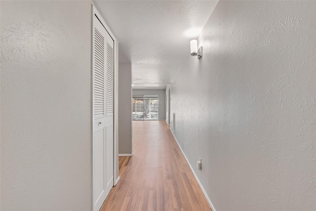 2002 Rose Hill Road Carrollton, TX 75007 - Photo 9 of 34 a view of a hallway with wooden floor