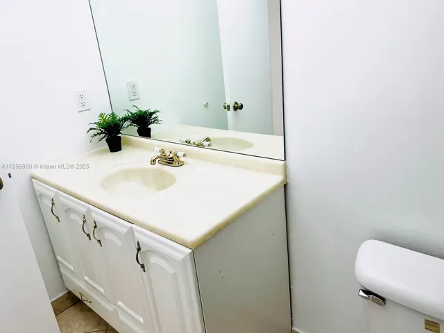 a bathroom with a sink a toilet and mirror