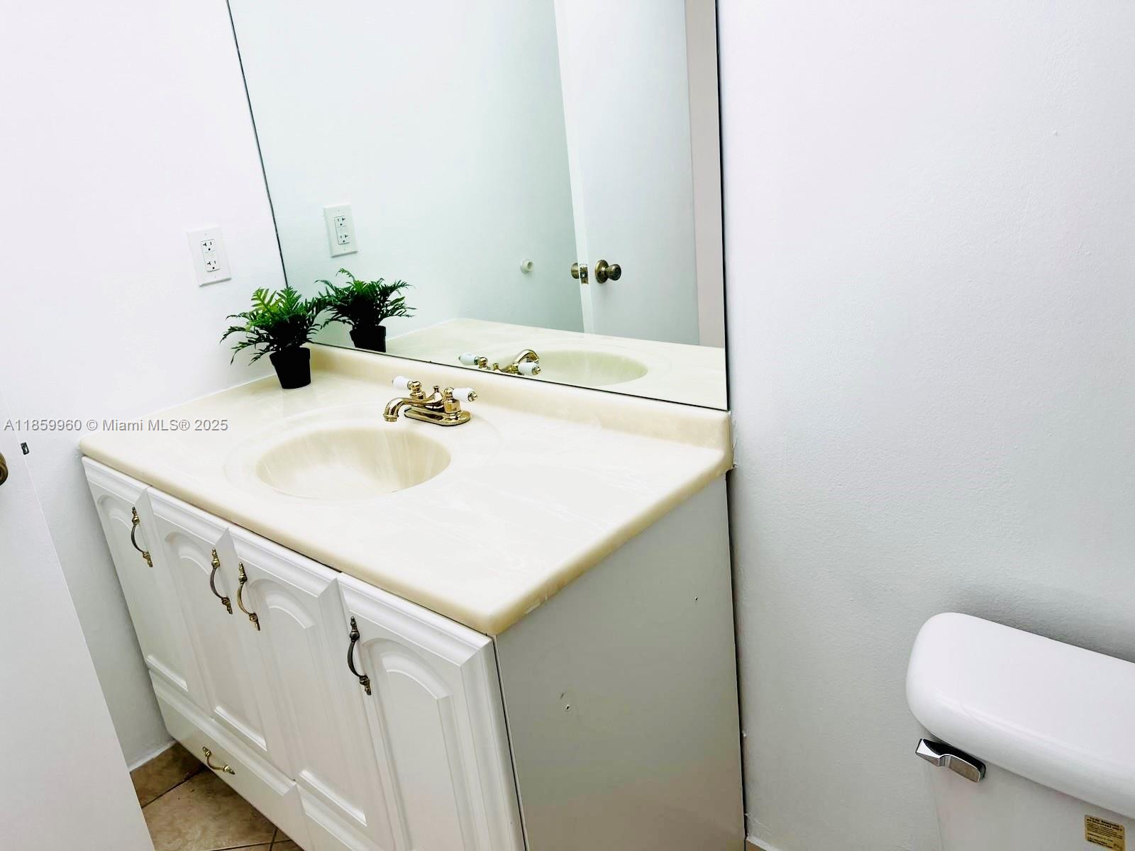 1810 Southwest 81st Avenue, Unit 2201 North Lauderdale, FL 33068 - Photo 11 of 32 a bathroom with a sink a toilet and mirror