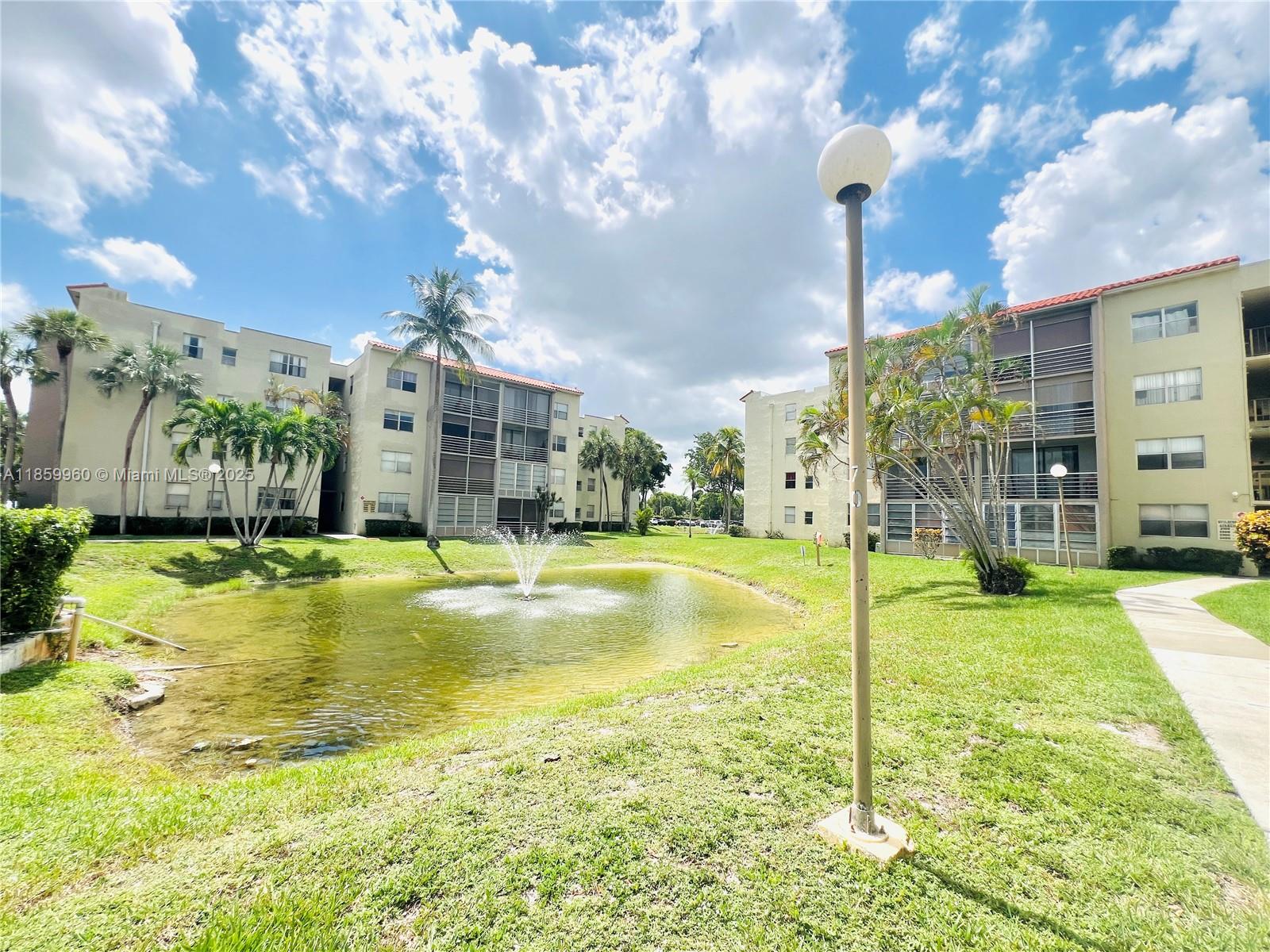 1810 Southwest 81st Avenue, Unit 2201 North Lauderdale, FL 33068 - Photo 14 of 32 a swimming pool with outdoor seating and yard