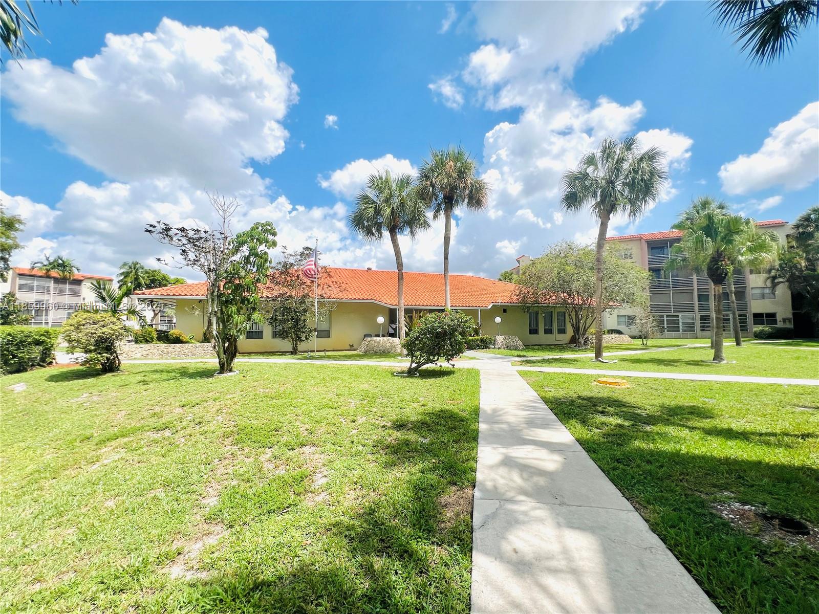1810 Southwest 81st Avenue, Unit 2201 North Lauderdale, FL 33068 - Photo 15 of 32 a view of a fountain in front of a house with a big yard