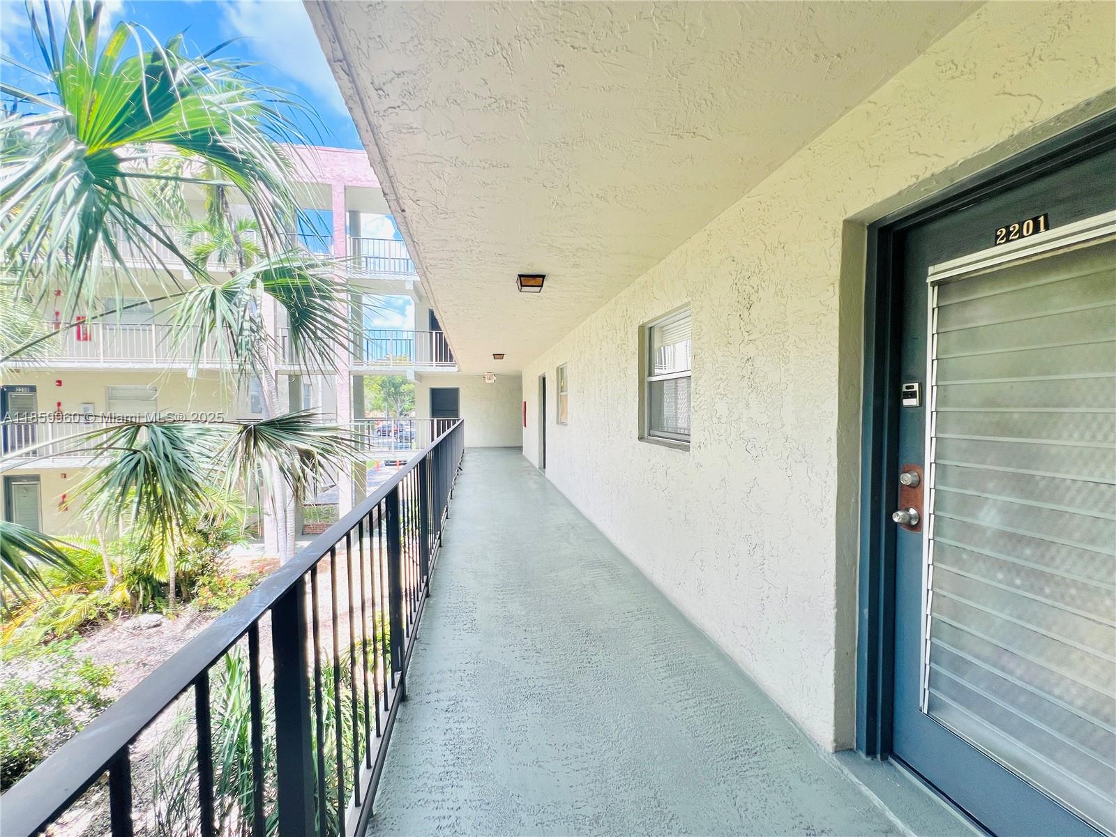 1810 Southwest 81st Avenue, Unit 2201 North Lauderdale, FL 33068 - Photo 20 of 32 a view of balcony with wooden floor and stairs