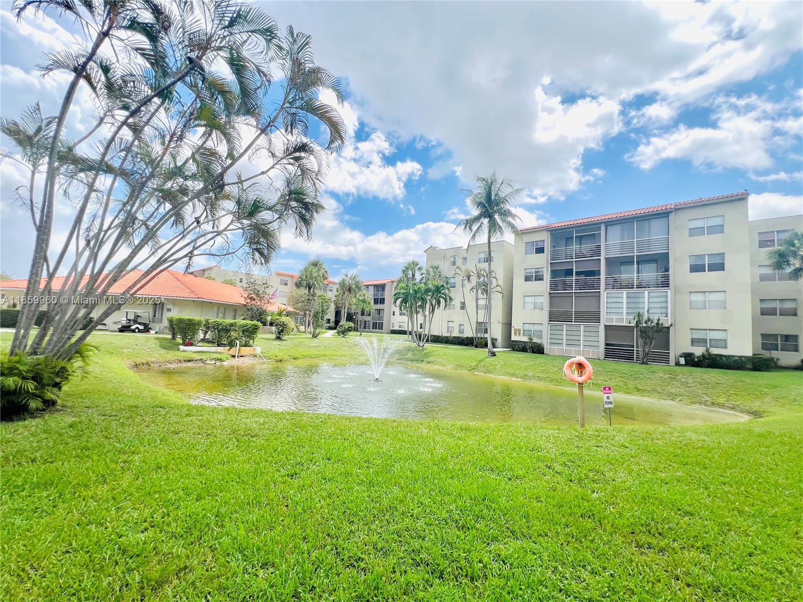 1810 Southwest 81st Avenue, Unit 2201 North Lauderdale, FL 33068 - Photo 21 of 32 a view of swimming pool in he middle of the green field